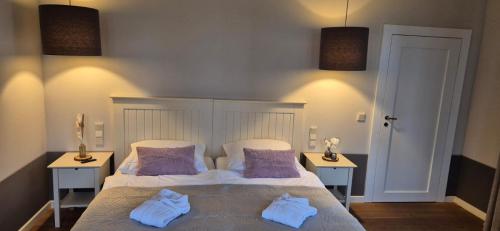 a bedroom with a bed with towels on it at Schlosshotel Hohenbocka in Hohenbocka
