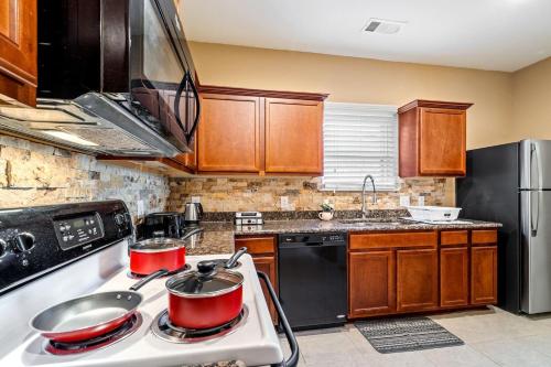a kitchen with two pots on top of a stove at One Level Home, Foosball, Crib, Office Space,yard in Crowley