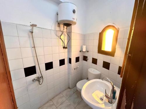 a small bathroom with a sink and a toilet at Amanda beach hotel in Dahab