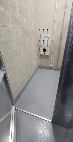 a bathroom with a urinal on a brick wall at Apartment VIVA TEBA Vrchlabí in Vrchlabí