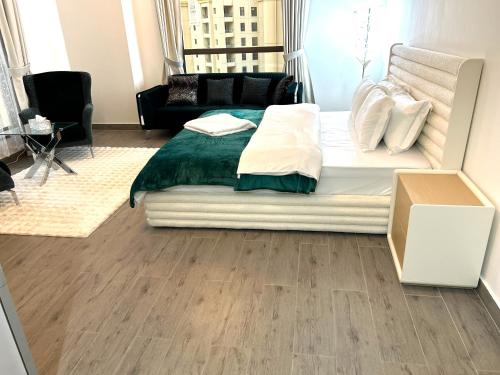 a bedroom with a bed and a living room at ROYAL BEACH RESIDENCES 2 in Dubai