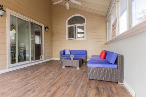 a screened porch with two chairs and a table at Barrie Bliss 3BR Haven near Centennial Beach in Barrie