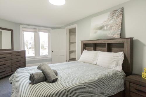 a bedroom with a bed with a stuffed animal on it at Barrie Bliss 3BR Haven near Centennial Beach in Barrie