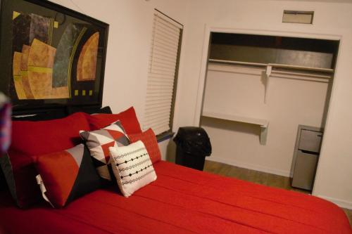 a bedroom with a red bed with red pillows at Cozy Private Room 2 with Extras in Dallas