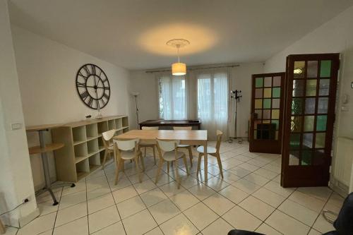 a kitchen with a table and chairs in a room at La Vallée 6 bedroom house Le Havre in Le Havre