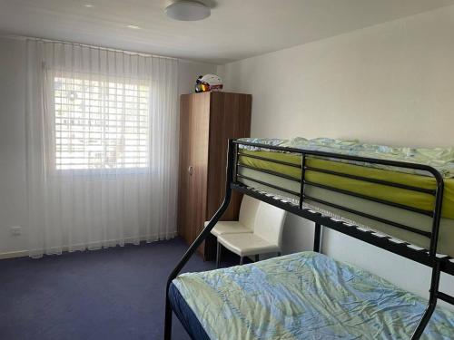 a dorm room with a bunk bed and a window at Superspot Ferienwohnung mit Super Aussicht in Churwalden