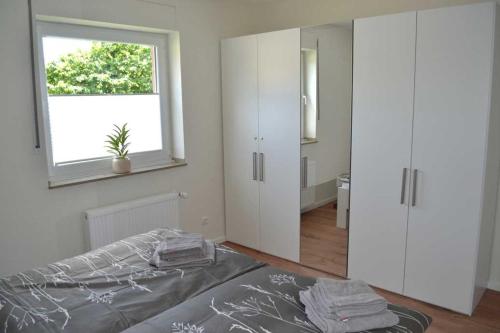 a bedroom with a bed and a window at 4 Sterne Wohnung Orchidee in Brüggen