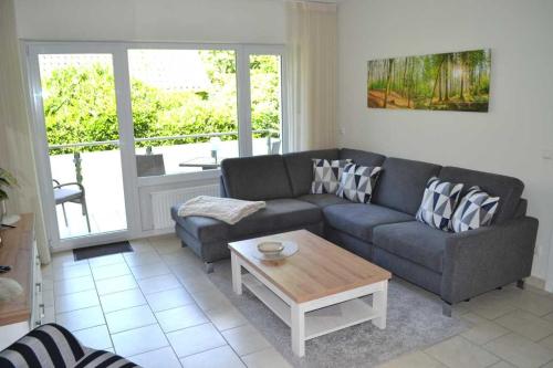 a living room with a couch and a coffee table at 4 Sterne Wohnung Orchidee in Brüggen