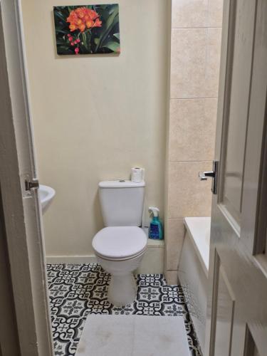 a bathroom with a toilet and a sink at The Reddish Retreat in Manchester