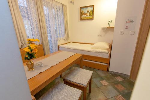 a small room with a table and a bed at Mama's House in Cerklje na Gorenjskem