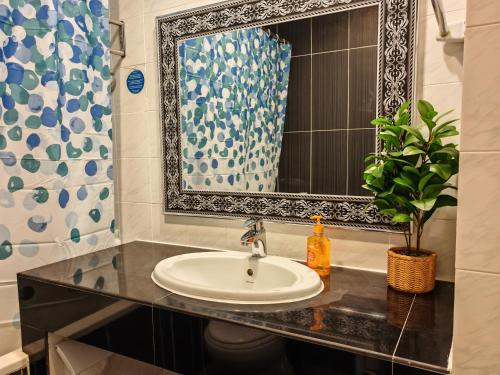 a bathroom with a sink and a mirror at Urban Oasis Apartment 6 in Melaka