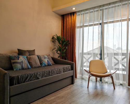 a living room with a couch and a chair at Urban Oasis Apartment 6 in Melaka
