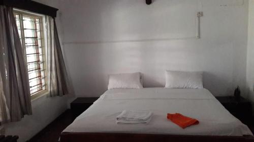 a bedroom with a bed with two towels on it at The New Big Tree Beach Resort in Mombasa
