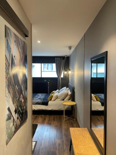 a bedroom with two beds and a mirror in a room at Les Cépages in Le Mesnil-sur-Oger