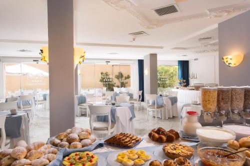 a table with various types of pastries in a room at Atlantic Palace Hotel in Sorrento