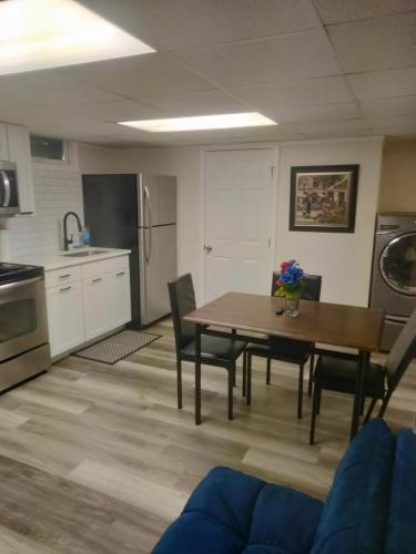 a kitchen with a table and chairs in a room at Attractive Lower Level Guest Suite with Private Entrance in Whitinsville