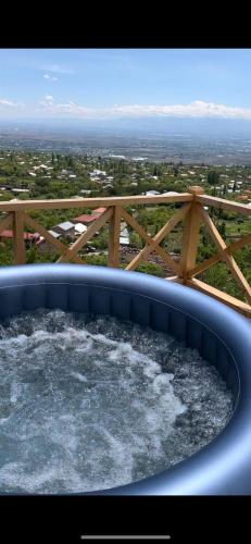 a hot tub with water in it on a balcony at IN CLOUDS RESORT Byurakan in Antarut