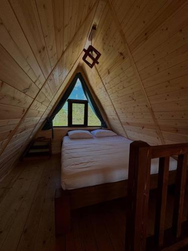 a large bed in a wooden room with a window at IN CLOUDS RESORT Byurakan in Antarut