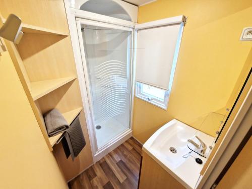 a small bathroom with a shower and a sink at Voll klimatisiertes Mobile Home mit Wi-Fi am Europa-Park in Boofzheim