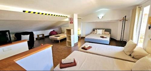 a room with two beds and a living room at Casa con piscina en costa Barcelona in Sant Vicenç de Montalt