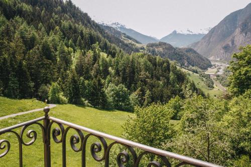 a view from a balcony of a valley with mountains at Klostergut Kronburg in Zams