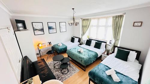 a living room with two beds and a couch at Isleworth House London by Smart Corporate Stays in London