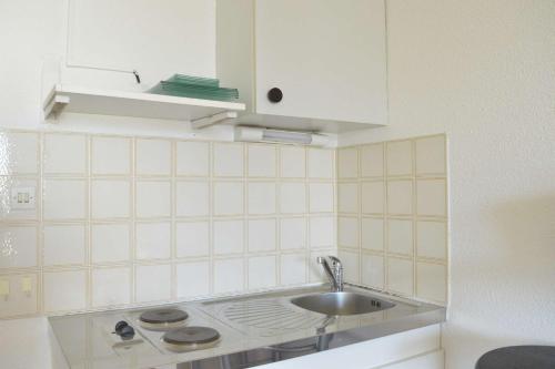 a kitchen with a sink and a white cabinet at Studio CAP D'AGDE CT121-019 in Cap d'Agde