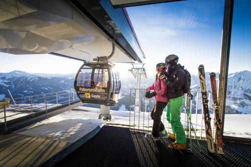 a man and a girl standing in a ski lift at Hotel Landhaus Zillertal in Fügen