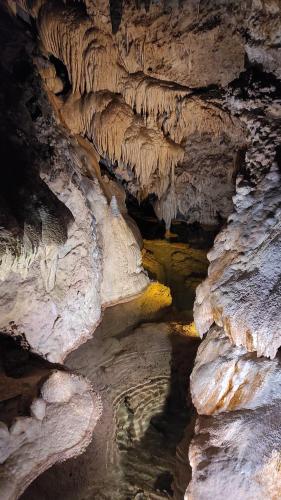 a cave filled with rocks and water with a yellow at Štýlový Zrub Martina A s kúpacou Kaďou a detským ihriskom! in Ždiar