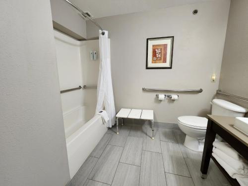 a bathroom with a tub and a toilet and a sink at Country Inn & Suites by Radisson, Topeka West, KS in Topeka