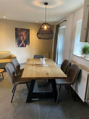 a dining room with a wooden table and chairs at Valley View 3 Atmospheric 5 person holiday home near Valkenburg in Voerendaal