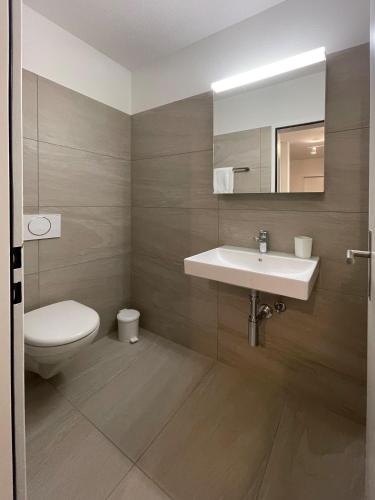 a bathroom with a sink and a toilet at Holiday flat for skiing couples Triangel D - Parpan Lenzerheide in Parpan