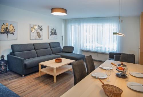 a living room with a couch and a table at Holiday flat for skiing couples Triangel D - Parpan Lenzerheide in Parpan