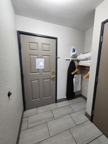 a room with a door and a tile floor at Country Inn & Suites by Radisson, Topeka West, KS in Topeka