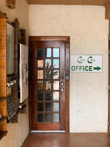 a door to a cafe office with a sign on it at Caye Casa in San Pedro