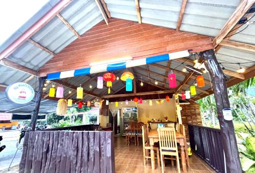 a restaurant with a table and chairs and lights at Sea Sun Bungalow in Ko Lanta