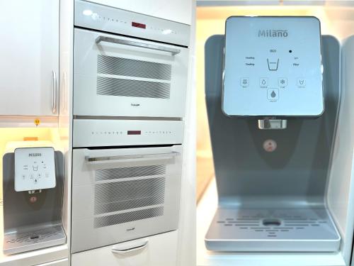 a refrigerator with its door open with a laptop in it at ROYAL BEACH RESIDENCES 2 in Dubai