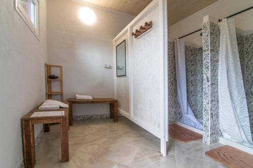 a room with a hallway with a table and a window at Agricampeggio Equinox in Carpignano Sesia
