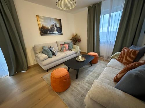 a living room with a couch and a table at ARGENTA Living 129 in Künzell