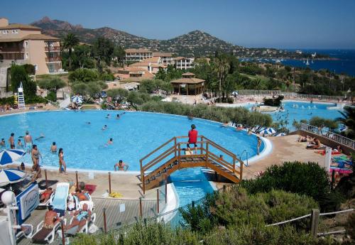 a large swimming pool with people in a resort at Cap Esterel Garden Flat in Agay - Saint Raphael