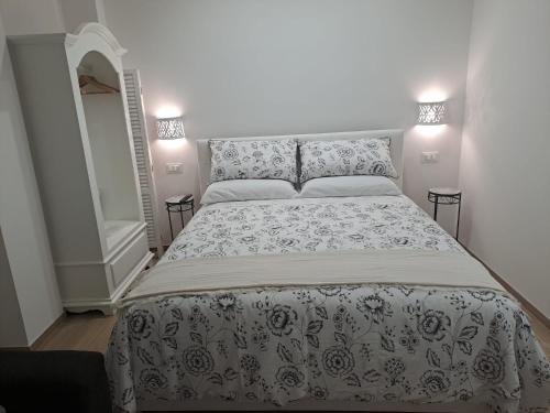 a bedroom with a bed with a black and white bedspread at Casa Mazzini 110 in Monopoli