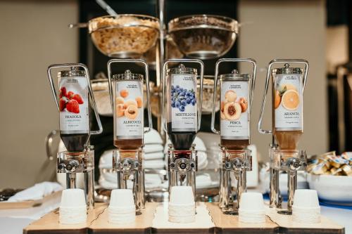 a row of wine glasses with different types of fruit at Hotel Galilei in Pisa