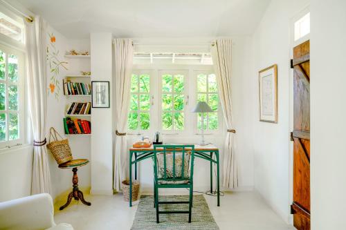 a green desk in a room with a window at The Sun House in Galle