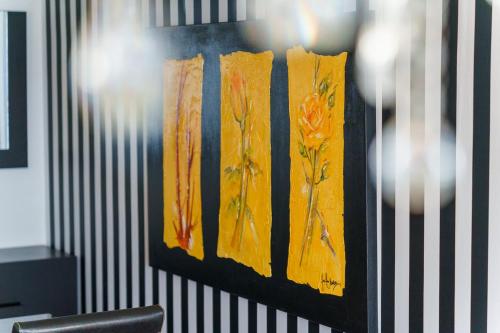 a painting of flowers on a wall in an office at GuestReady - Breathtaking seaview in Caniço in Caniço