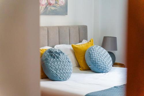 a bed with two blue pillows on top of it at GuestReady - Breathtaking seaview in Caniço in Caniço