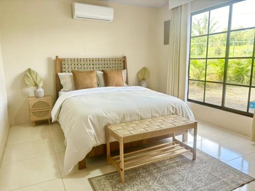 a bedroom with a large bed and a window at Arenal by the river in San Francisco
