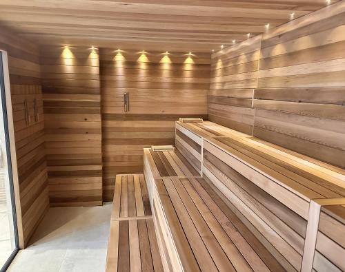 a sauna with wooden benches in a room at Predela 2 Aparthotel in Bansko