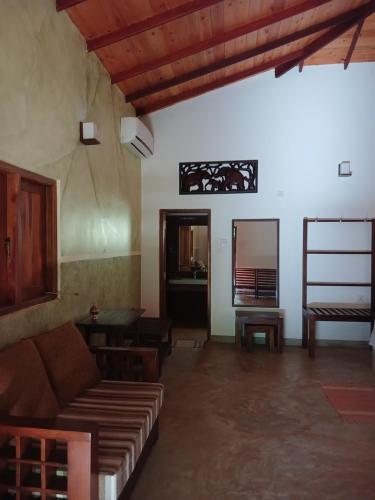a living room with a couch and a table at Villa Habarana in Habarana