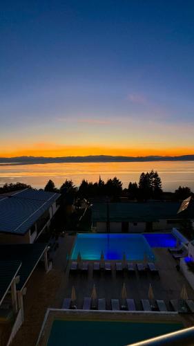 a view of a swimming pool at sunset at Vila Bisera in Ohrid