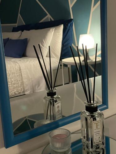 two glass bottles on a table in front of a mirror at La dimora di Sandy in Viterbo